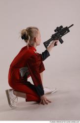 DENISA KNEELING POSE WITH GUN